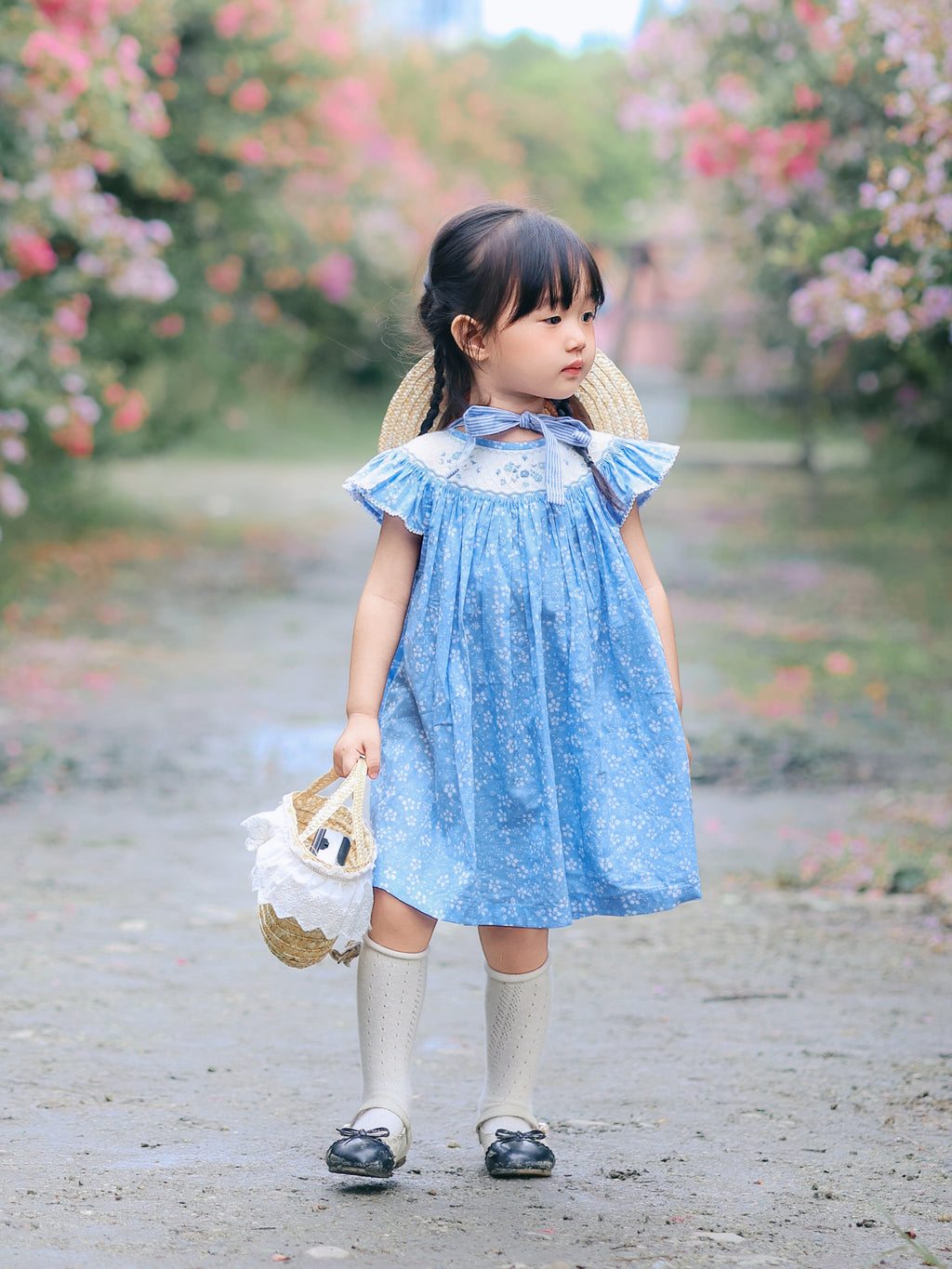 Detail of lace yoke and neckline on blue floral smocked dress