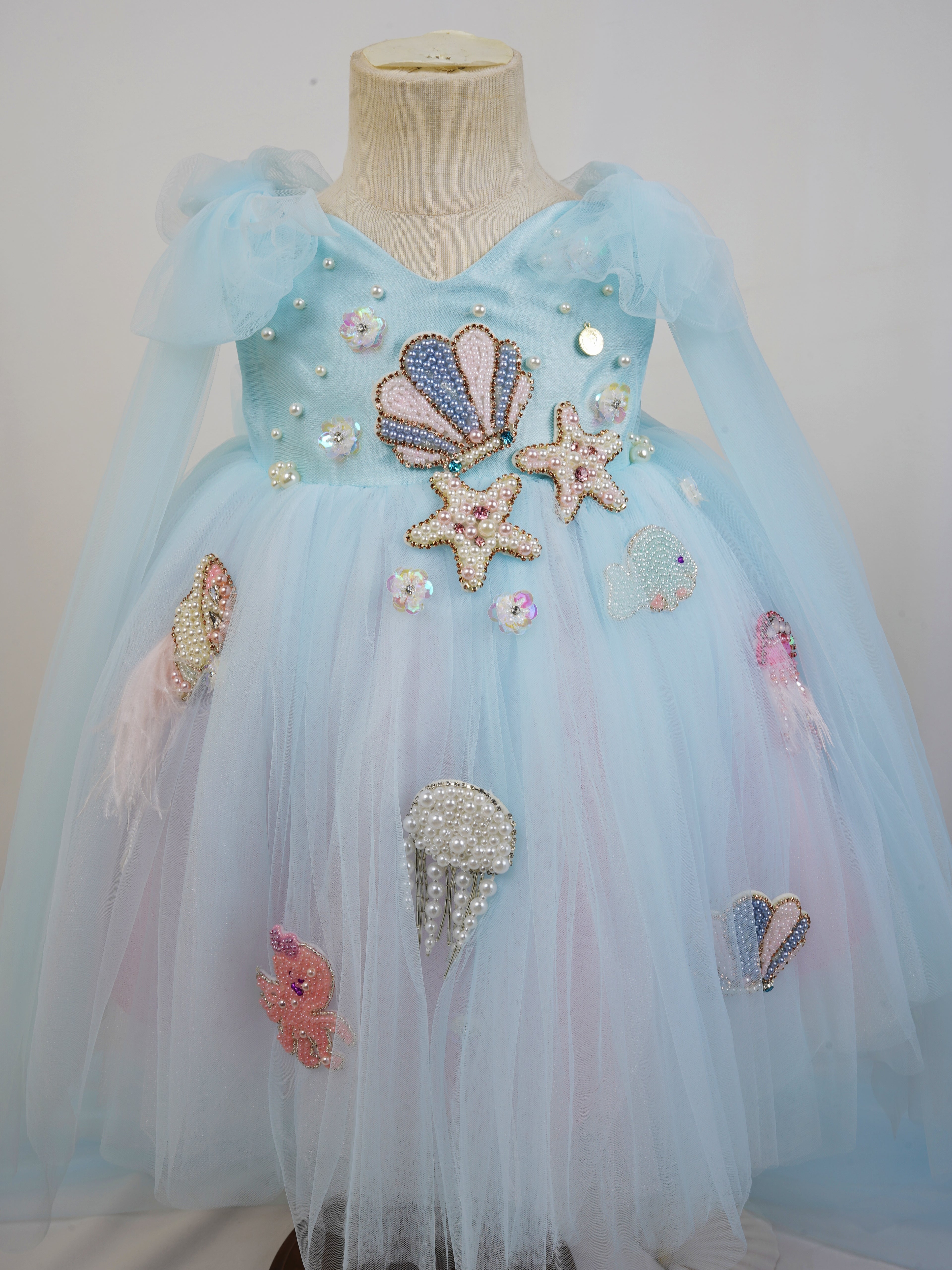 close up of pearl shell and starfish appliques with sequins