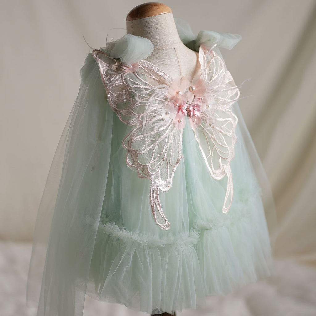 Back view showing butterfly wings detail on mint tulle dress