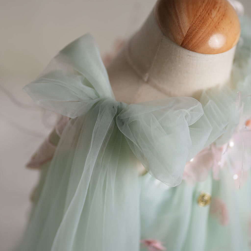 Shoulder bow and cape-like tulle detail on fairy dress