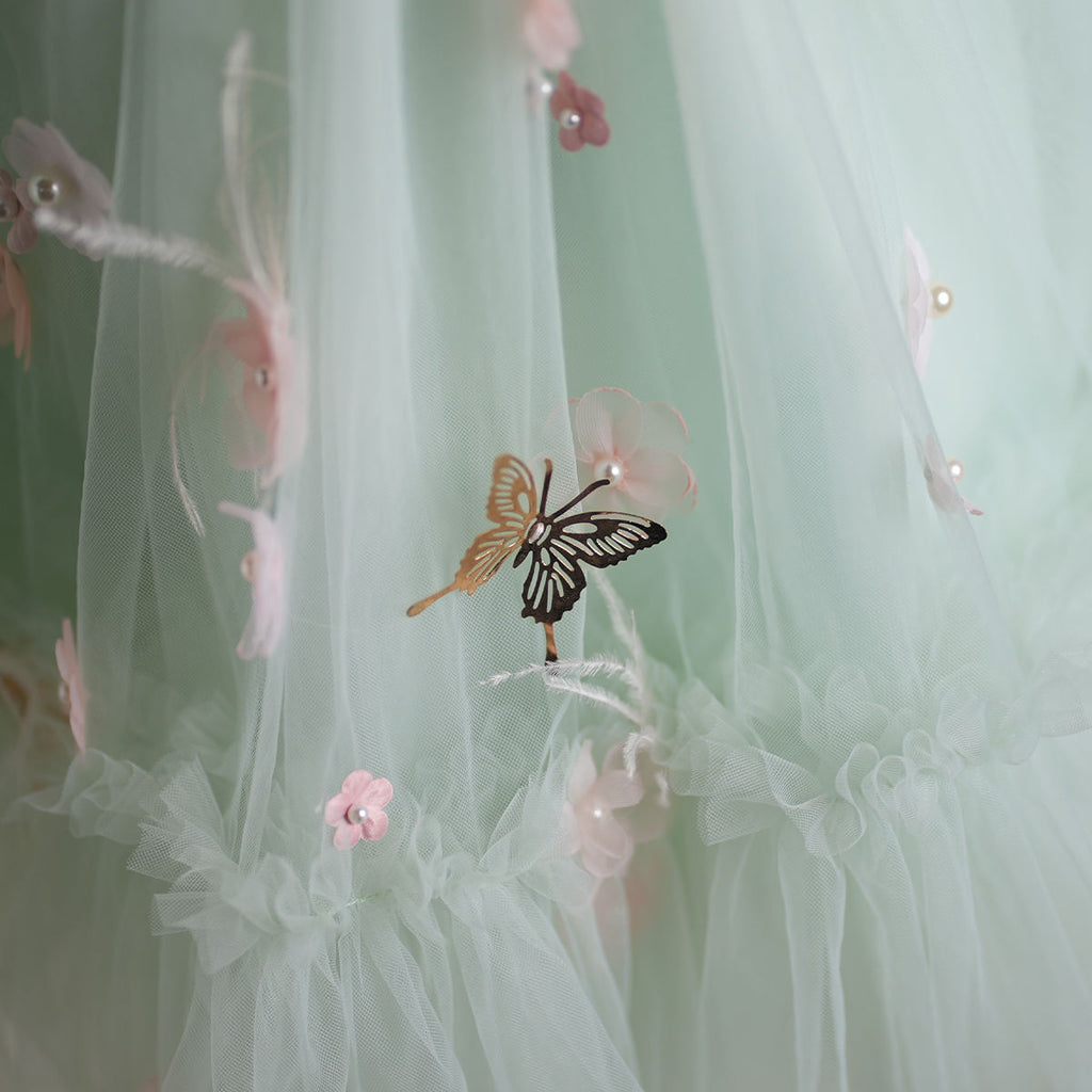 Skirt detail with butterfly and floral appliqués