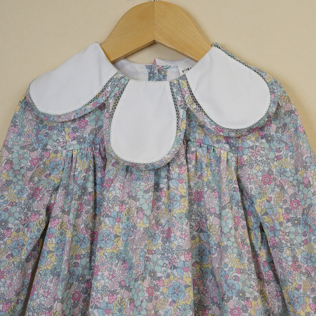 Close-up of signature petal collar with trim on floral dress