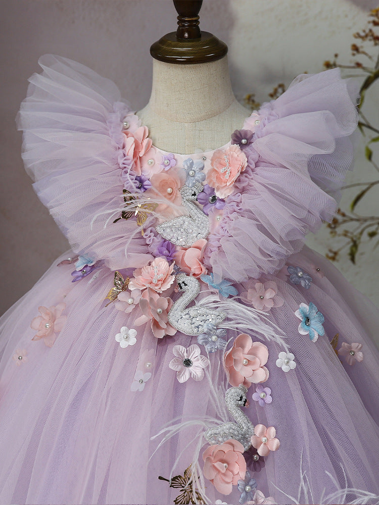 Close-up of pearl swan appliqués and 3D flowers on lilac tulle dress