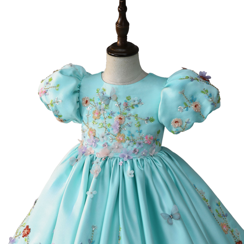 3D floral and butterfly appliqués on bodice, detail view