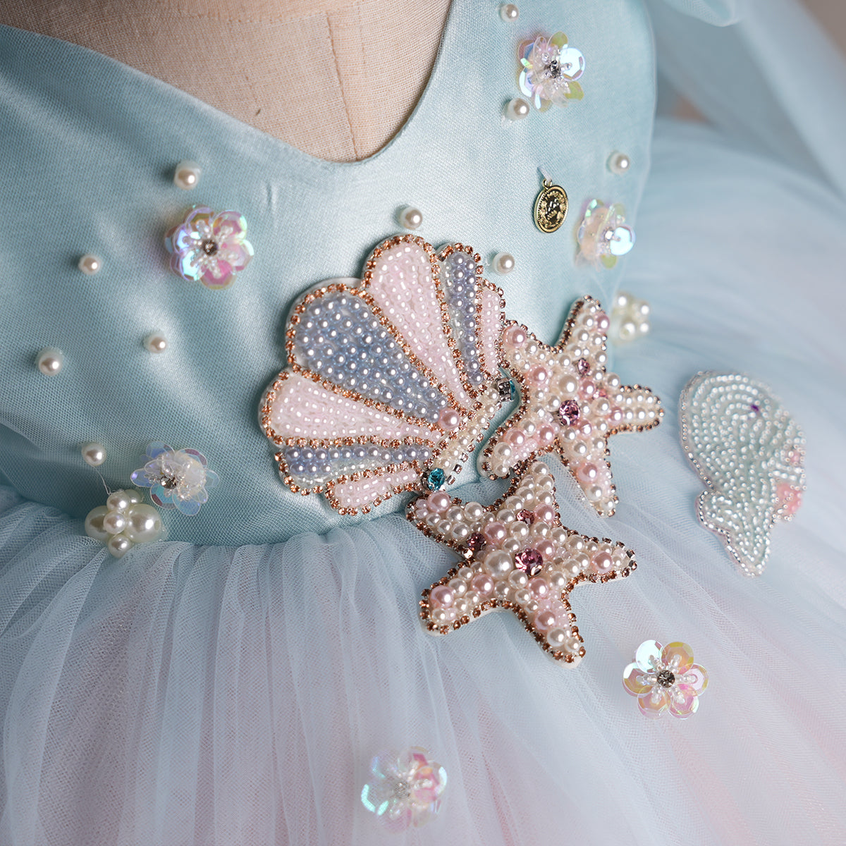 Bodice view with pearls and floral sequins on aqua satin