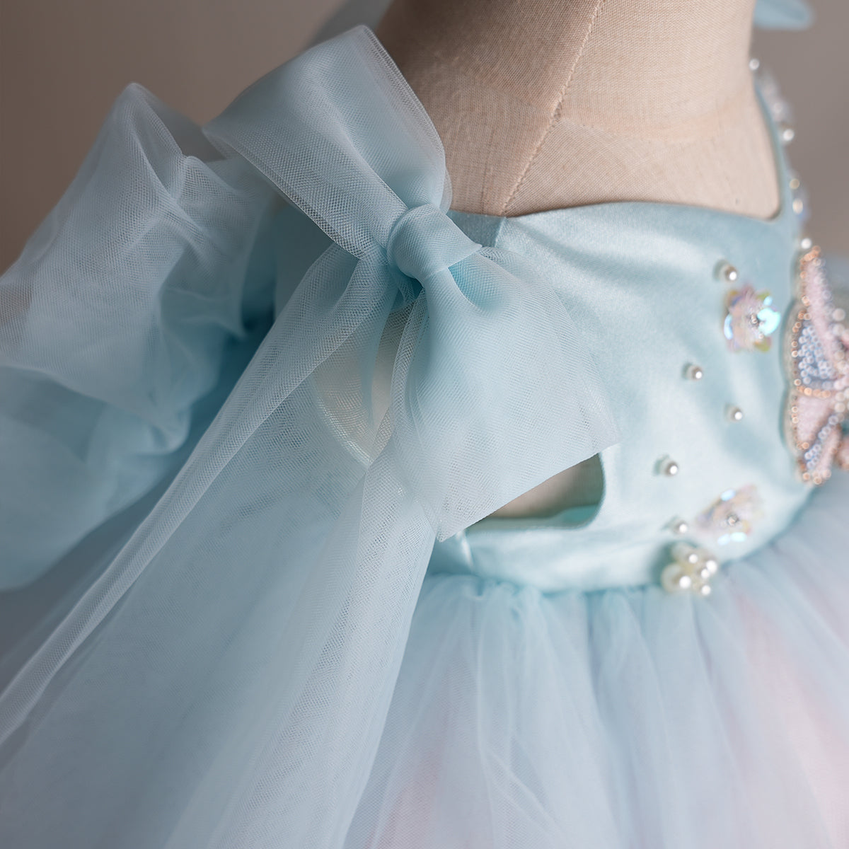 Aqua tulle shoulder bow detail on satin bodice