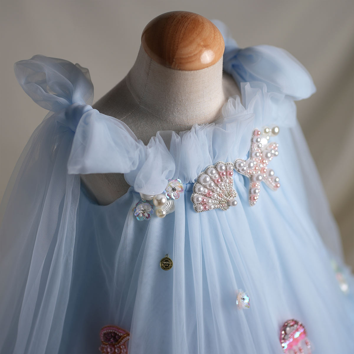 Close-up of seashell and starfish appliqués with pearls