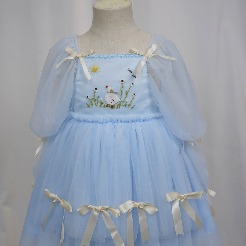 Full front view of layered light blue tulle skirt with bows