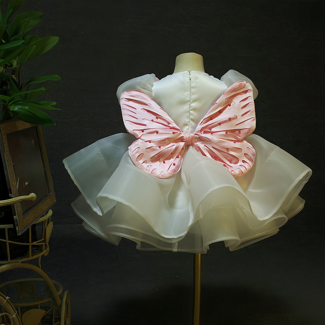 back view with pink detachable butterfly wings on white dress