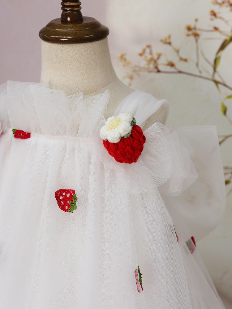 Crochet strawberry shoulder detail on white tulle dress
